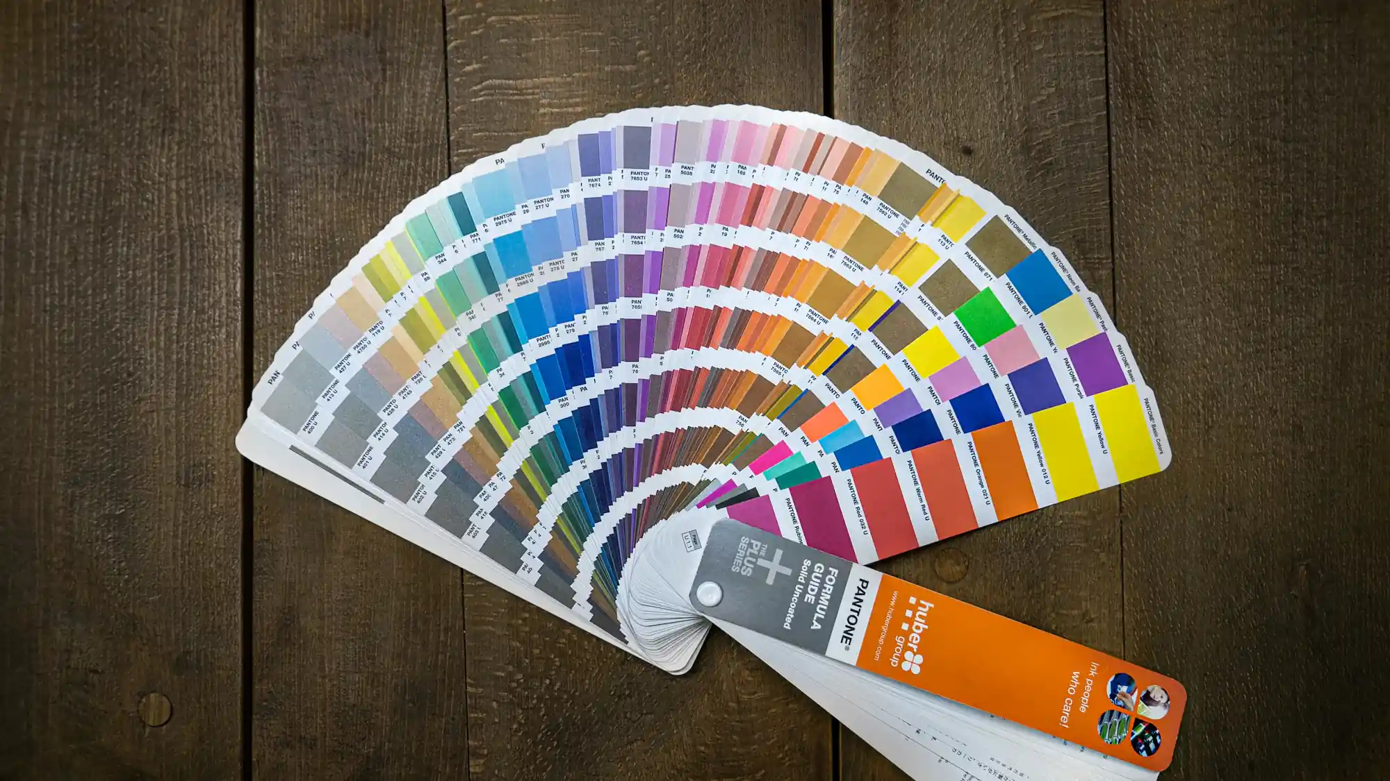 A fan of colour swatches on a wooden table