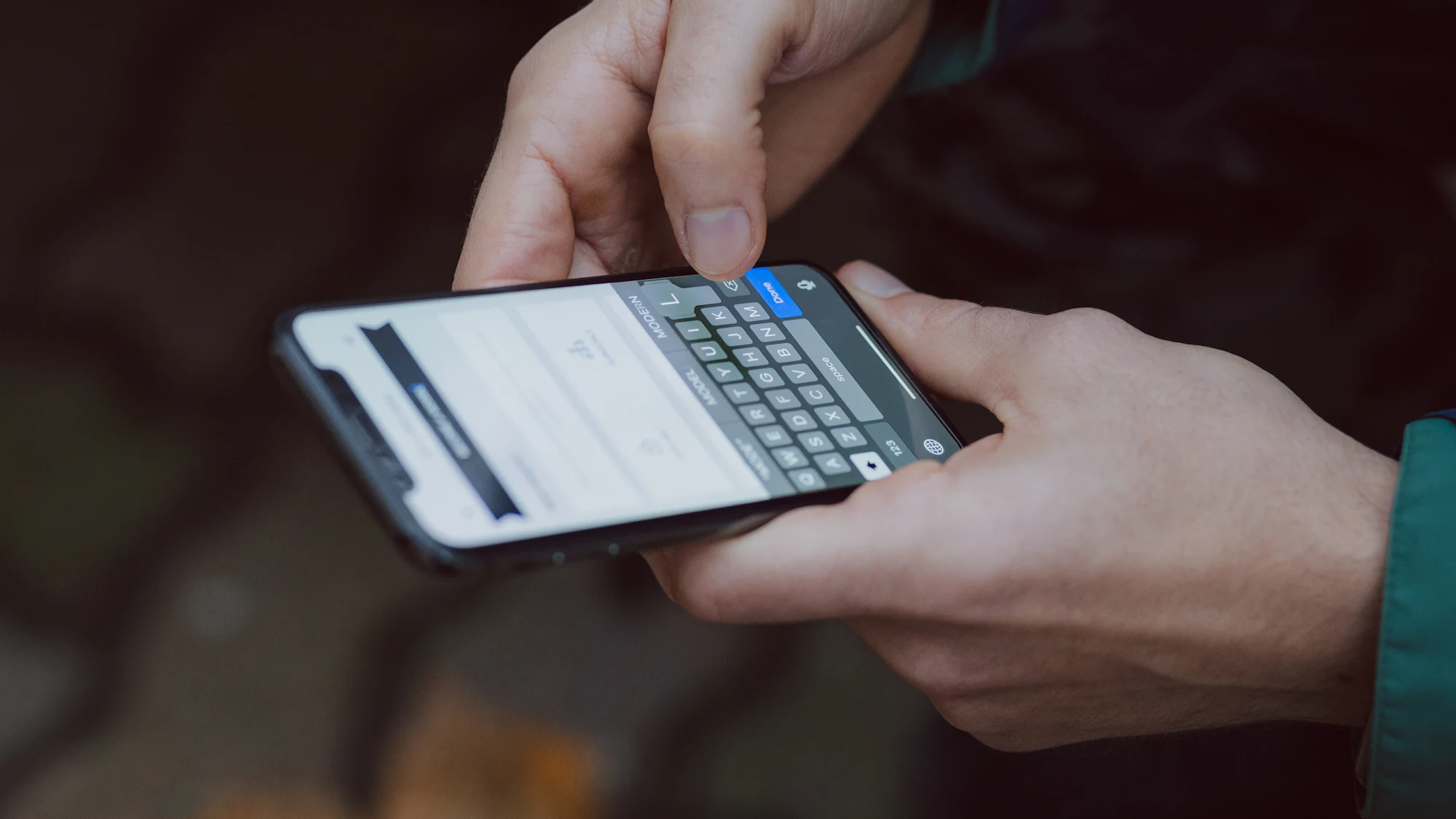 Thumbs typing a message on a smartphone