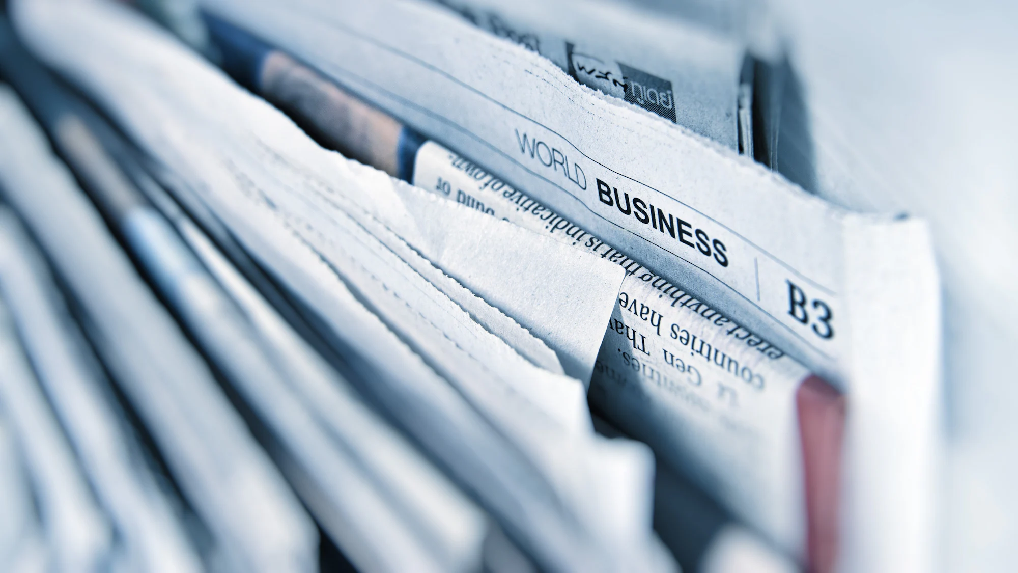A close up of a stack of business newspapers