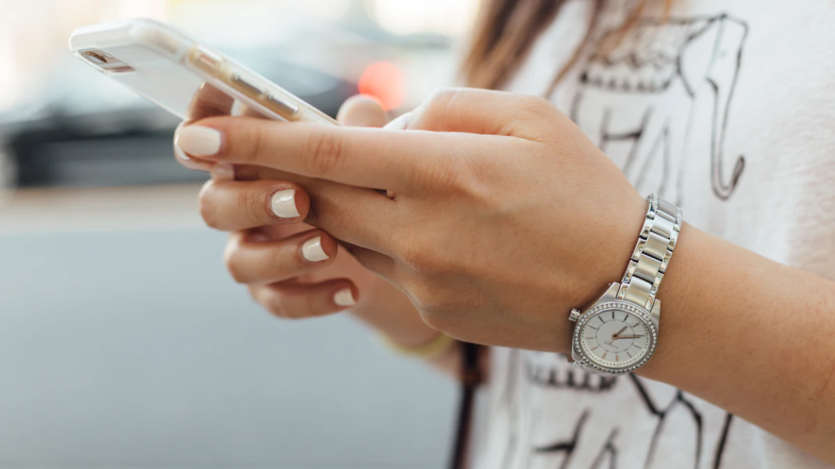 A woman wearing a silver watch holding a smartphone in both hands